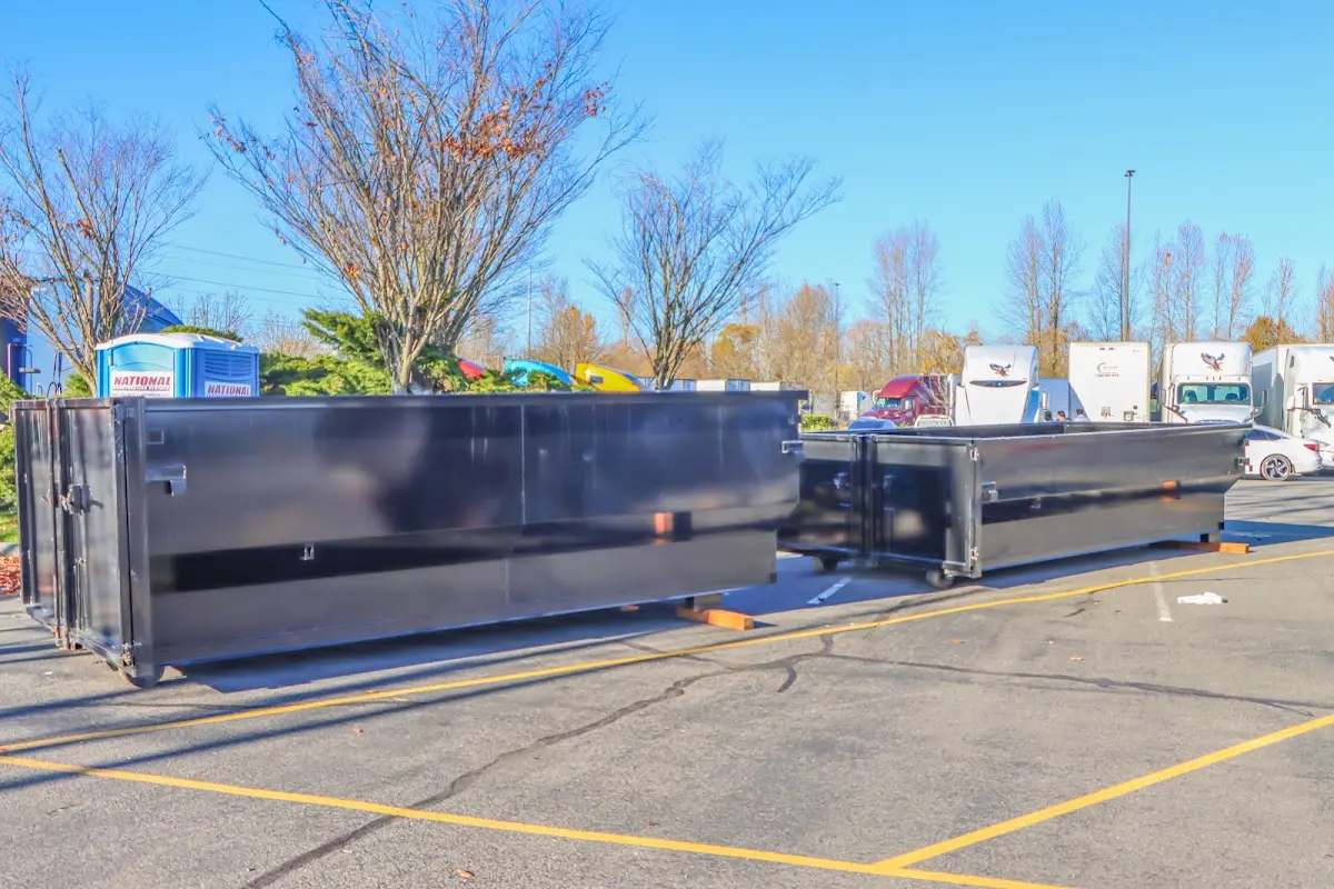 Professional dumpster rental service with roll-off container on residential driveway in Bergenfield